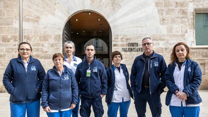 Trabajadores de la contrata de limpieza de las Cortes Valencianas, que llevan desde septiembre sin cobrar sus salarios, en la entrada principal del Parlamento autonómico.