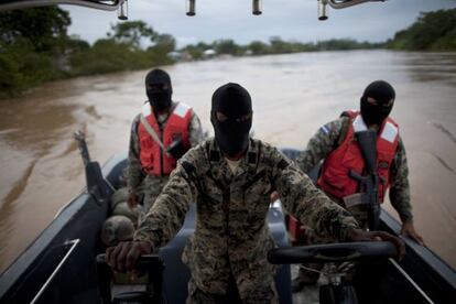 Honduran navy officers patrol the Patuca River near where last week&#039;s shooting incident occurred.