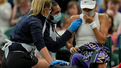 Britain's Emma Raducanu receive medical attention during the women's singles fourth round match against Australia's Ajla Tomljanovic on day seven of the Wimbledon Tennis Championships in London, Monday, July 5, 2021. (AP Photo/Alastair Grant)