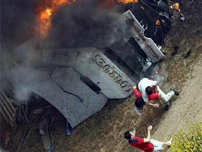 Vicente Sánchez carga en su espalda al camionero Rubén Escudero, ante la mirada de otro testigo.