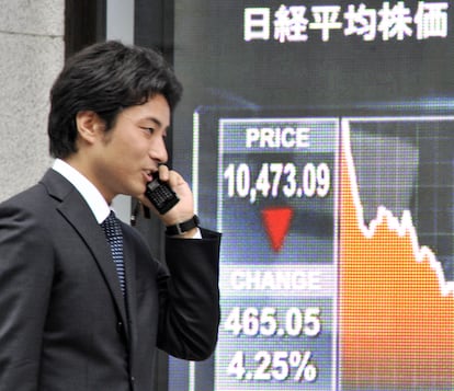 A businessman talks on the phone in Tokyo in 2008.