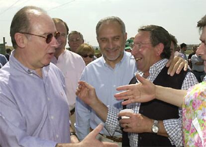 El vicepresidente segundo del Gobierno y ministro de Economía, Rodrigo Rato, junto al candidato popular a la Alcaldía de Móstoles, Esteban Parro (c), saluda a los simpatizantes de su partido que acudieron al mitin del PP que tuvo lugar en la Finca La Princesa de Móstoles.