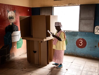 Una mujer dobla su papeleta de voto en una cabina de votación en Luanda, este miércoles.