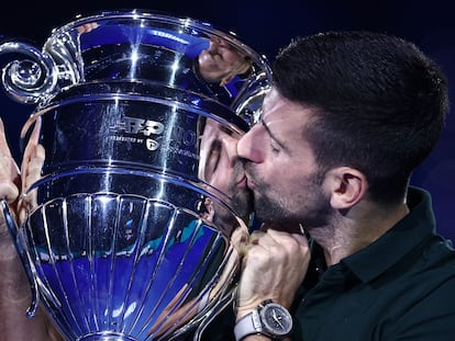 Novak Djokovic poses as he celebrates with the trophy for his 2023 world number one ranking