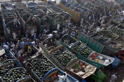 Agricultores paquistaníes en el mercado de frutas de Lahore para vender sus sandías.