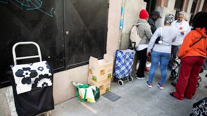 Voluntarios entregan comida a personas en situación de vulnerabilidad, el 23 de mayo de 2023 en Madrid.