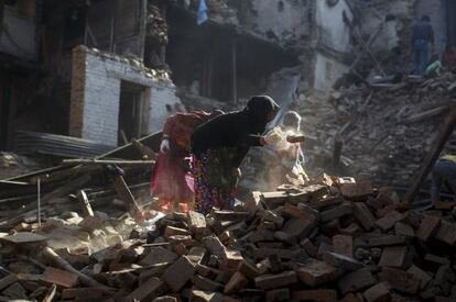 Habitantes de las zonas afectadas por el terremono en Nepal limpian los escombros en los que han quedado sus hogares.