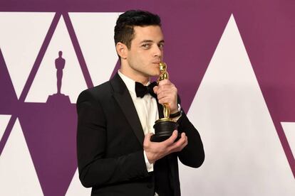 Rami Malek, ganador a mejor actor, besa su Oscar.