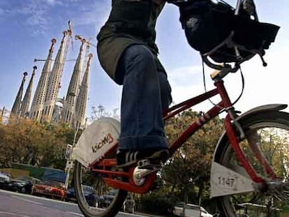 Una ciclista pasa por el carril bici junto a la Sagrada Familia.