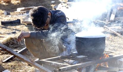 Un chico cocina comida en el campamento de Lipa el 18 de febrero de 2021.