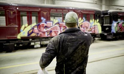 One of the graffiti artists takes a picture of the recently painted 1926 train.