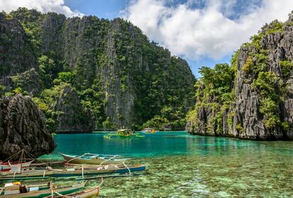 Pequeñas barcas locales en la isla de la laguna de Coron, Palawan (Filipinas).