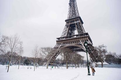 Un hombre juega con nieve cerca de la Torre Eiffel, que se encuentra cerrada debido a la intensa nevada. El instituto de Metereología de Francia espera hasta 20 centímetros de nieve en la capital y temperaturas de -10 grados.