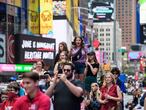 People watch a pop up event in Times Square on June 11, 2021 in New York City. - Many restrictions aimed at curbing the spread of the virus have been lifted, and New York state governor Andrew Cuomo said that most of the remaining measures would be eliminated once 70 percent vaccination is achieved. (Photo by Angela Weiss / AFP)