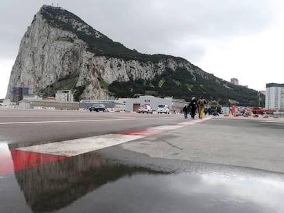 People walk by Gibraltar's airport.