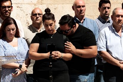 Un momento de la concentración llevada a cabo este jueves en Alzira (Valencia) en repulsa por  el asesinato de su vecina Raquel Lorente ayer, presuntamente por su exmarido, y a la que han asistido sus hijos Raquel y Juan (en la imagen).