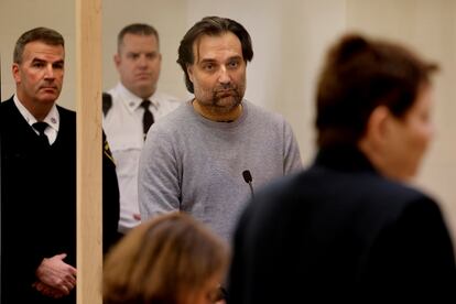 Brian Walshe, center, listens during his arraignment Wednesday, Jan. 18, 2023, at Quincy District Court, in Quincy, Mass., on a charge of murdering his wife Ana Walshe.