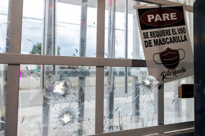 Bullet holes pierce a front window at the Piel Kanela restaurant-bar and mini-market in San Juan, Puerto Rico, Monday