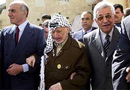 Arafat, flanqueado por Abu Mazen (derecha) y el millonario palestino Munib al Masri (izquierda), en Ramala.