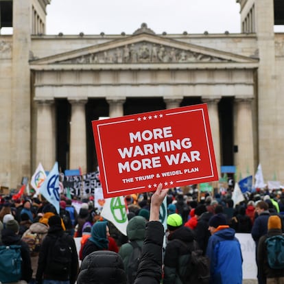 A demonstrator holds a placard during a protest on sidelines the Munich Security Conference (MSC), in Munich, Germany February 14, 2025. REUTERS/Kai Pfaffenbach