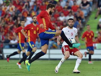 Gerard Piqué controla un balón adelante de Lado Dvalishvili de Georgia durante la EURO 2016.