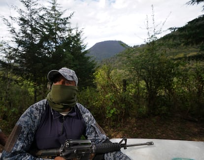 A community police officer patrols a forest in search of loggers and illegal avocado plantations, in Cherán, Michoacán, in January 2022.