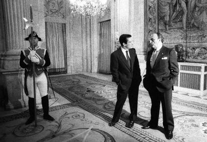 Adolfo Suárez (izquierda) y Manuel Fraga conversan ante un guardia en el Palacio Real, durante la recepción, en diciembre de 1988, con motivo del décimo aniversario de la Constitución.