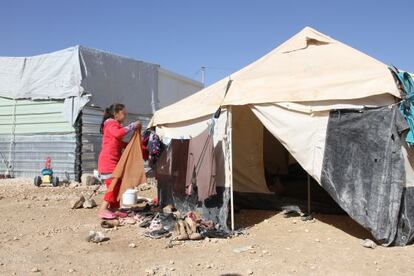 Zeinab de nueve a&ntilde;os, tiende la ropa en el campo de Zaatari. 
