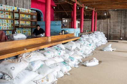 Sand bags are piled up in front of a bar to prevent flooding as Hurricane Norma barrels towards the Baja California peninsula, in Cabo San Lucas, Mexico, October 20, 2023.