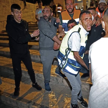 An injured man is carried away as Israeli security forces clash with Palestinian protesters at the al-Aqsa mosque compound in Jerusalem, on May 7, 2021. (Photo by ahmad gharabli / AFP)