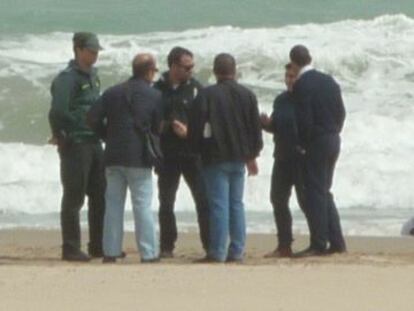 Agentes de la Guardia Civil y vecinos junto al cadáver hallado en la playa de la Zenia de Orihuela.