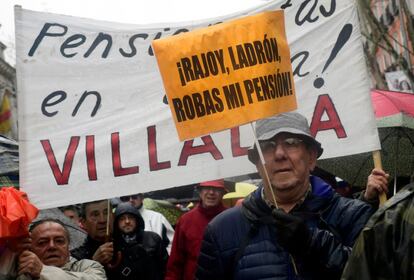 Un pensionista sosté un cartell sota el lema "Rajoy, lladre, robes la meva pensió!" a la marxa de Madrid.