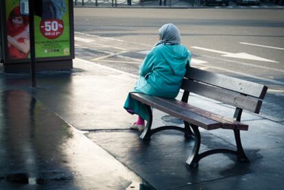 Una mujer descansa en un banco de Saint-Ouen, la <i>banlieue</i> del norte de París.