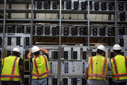 Workers at a bitcoin mine in Whinstone, Texas.