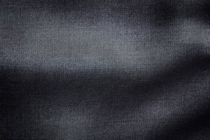 Close up of dark tencel fabric. Tencel (Lyocell) is a form of rayon that consists of cellulose fibre made from dissolving pulp. Top view. Copy space.