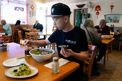 Kevin Mok, owner of Mr Obanyaki ice cream shop, near the Star Ballroom Dance Studio, eats noodles at Mandarin Noodle House on Tuesday, Jan. 24, 2023, in Monterey Park.