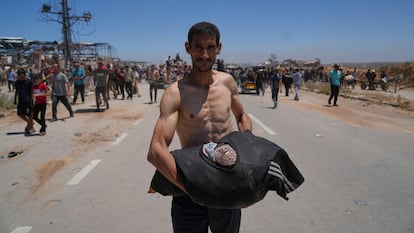 A Palestinian carries food supplied by the Gaza Humanitarian Foundation, Thursday in Khan Yunis.