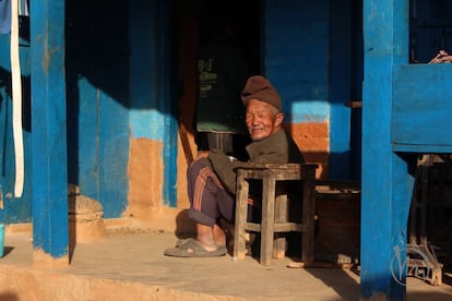 Taking it easy, a local shopkeeper waits for custom.