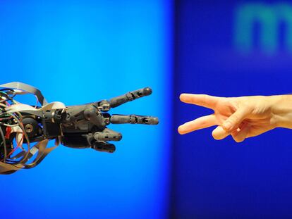 Máquina frente a ser humano: un científico juega con un robot en el Museo de la Ciencia de Londres.