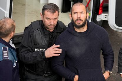 Police officers escort Andrew Tate, right, handcuffed to his brother Tristan Tate, to the Court of Appeal in Bucharest, Romania, Wednesday, Feb. 1, 2023.