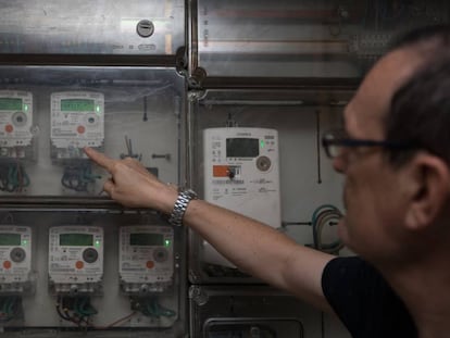 Un operario lee contadores de electricidad en un edificio.