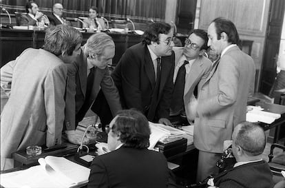 De izquierda a derecha, Gabriel Cisneros, José Pedro Pérez-Llorca, Gregorio Peces-Barba, Miguel Herrero y Miquel Roca, en presencia de Jordi Solé Tura y Manuel Fraga (de espaldas), antes de proceder a la votación de la Constitución en 1978. 
