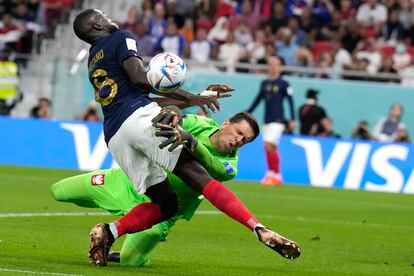 Dayot Upamecano, izquierda, y Wojciech Szczesny chocan durante el partido de octavos de final.