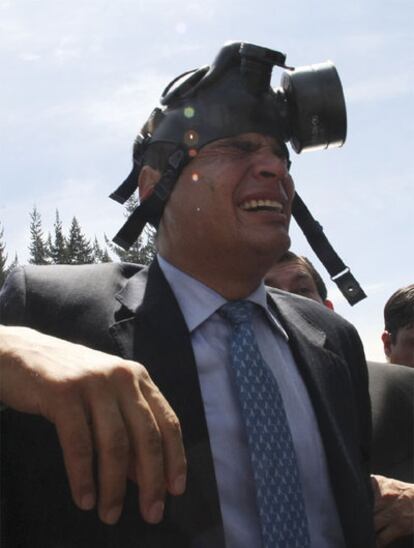 El presidente de Ecuador, Rafael Correa, con una máscara para protegerse de los gases lacrimógenos lanzados por la policía.
