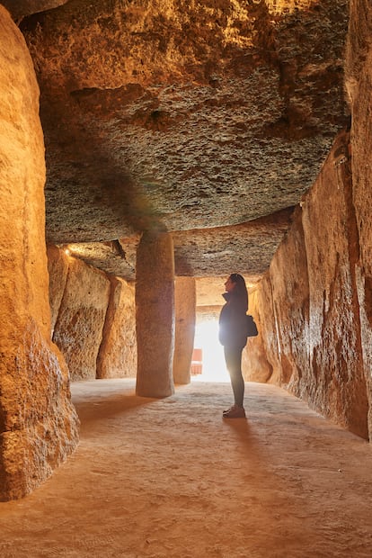 A woman inside the megalithic monument in 2023.