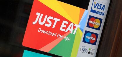 FILE PHOTO: Signage for Just Eat is seen on the window of a restaurant in London, Britain, August 5, 2019. REUTERS/Toby Melville/File Photo