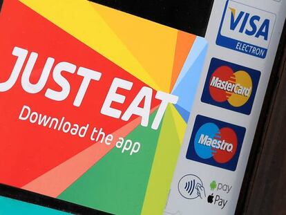 FILE PHOTO: Signage for Just Eat is seen on the window of a restaurant in London, Britain, August 5, 2019. REUTERS/Toby Melville/File Photo