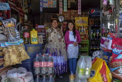 Lucia Mayta, de 43 años, y su hija Luz Cecilia, de 12, posan dentro de su bodega en La Paz, Bolivia. Lucía estudió hasta el cuarto grado de primaria y sabe leer, escribir y matemáticas básicas; se encarga de la bodega. Viven con el resto de la familia en la parte trasera del negocio y sueña con construir una casa en el futuro. Luz Cecilia está en séptimo grado y quiere ser cantante.