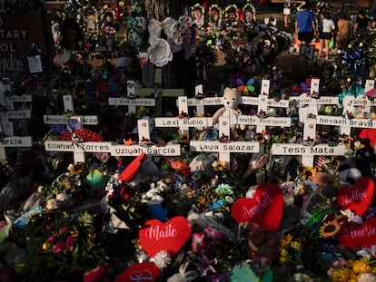 Flowers are piled around crosses with the names of the victims killed in a school shooting as people visit a memorial at Robb Elementary School to pay their respects May 31, 2022, in Uvalde, Texas.