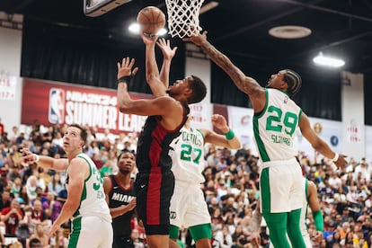 Miami Heat center Orlando Robinson, center front, makes a basket as Boston Celtics guard Jay Scrubb (29) tries to keep him from the net during an NBA Summer League basketball game Saturday, July 8, 2023, in Las Vegas.